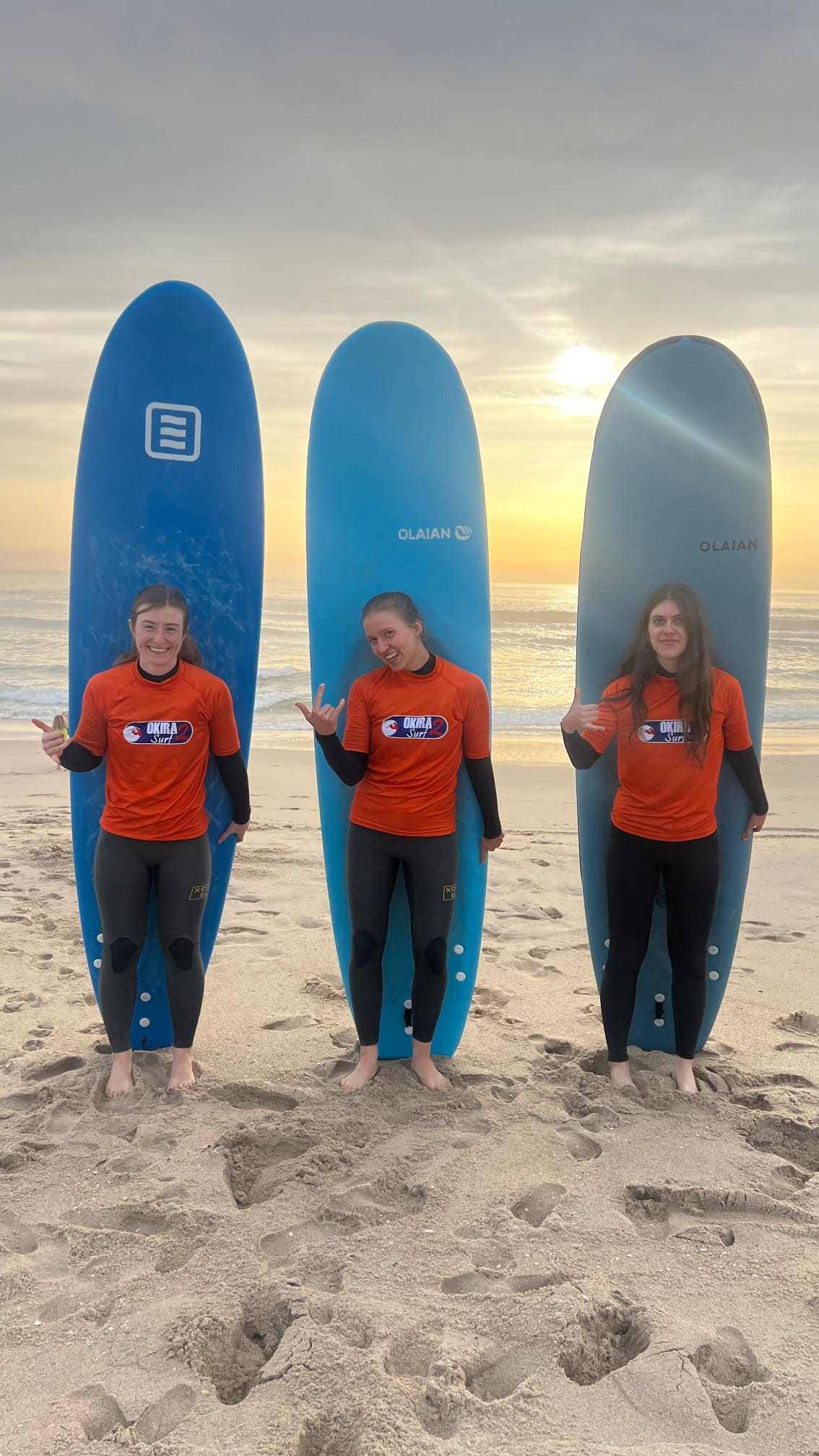 Group in Okira Surf shirts at Praia da Aguda — surf lessons Porto, Gaia and surf Portugal