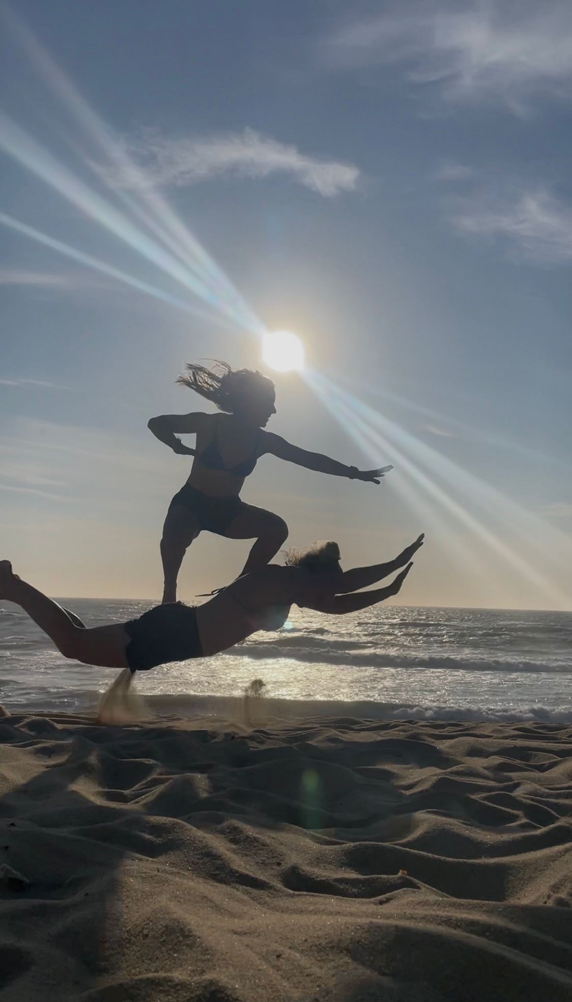 Silhouette fun on the sand at sunset — surf Gaia Portugal beach lifestyle